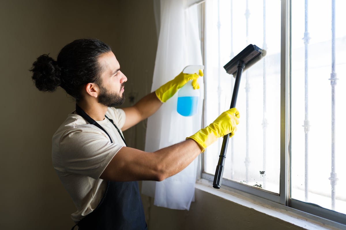 Professional window cleaner at work